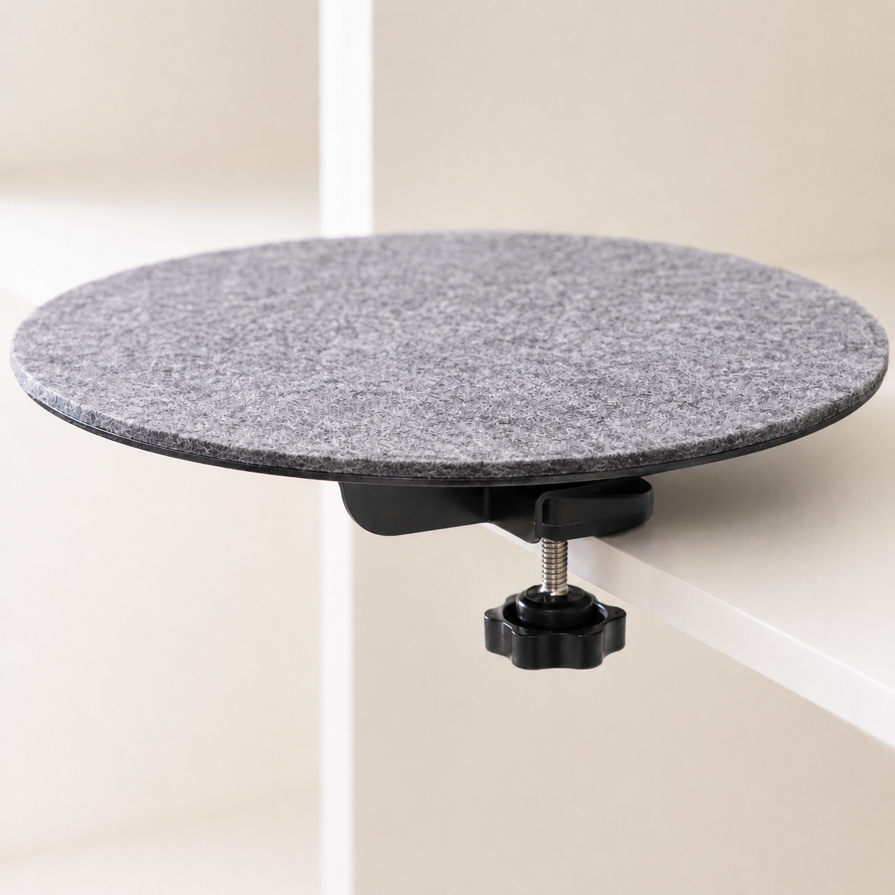 Black clamp-on cat shelf with dark gray felt pad on white furniture