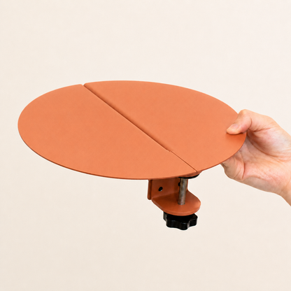 Terracotta two-piece clamp-on cat shelf held by hand